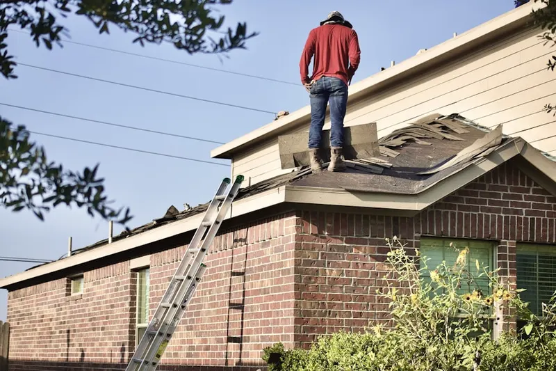 Professional roofer working on a residential roof in Patapsco Overlook